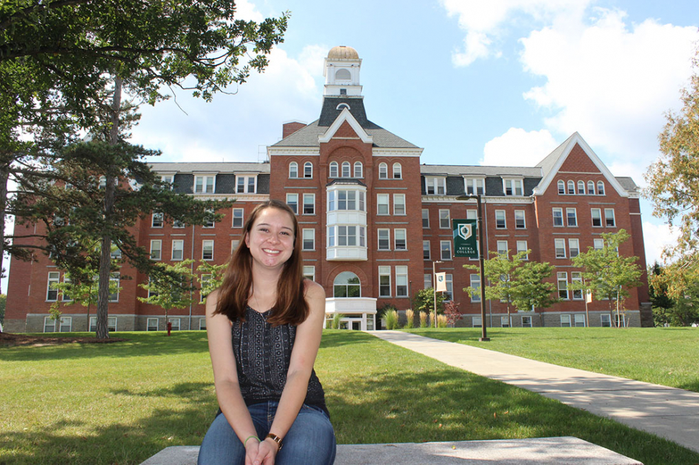 Tessa Alianell sitting outside of Ball Hall